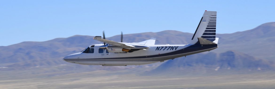 The Carson City Airport in Carson City Nevada, photo of a two prop plane in flight.
