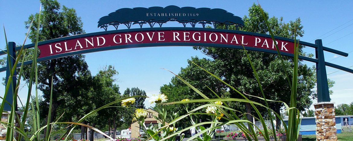 Island Grove Regional Park entrance sign with flowers in front.