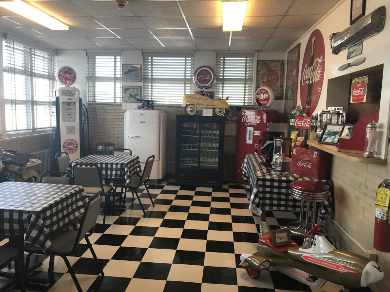 Lee Gilmer Memorial Airport in Gainesville Florida, old time looking interior with old coca cola signs, an old fridge and one or more old gas pumps.