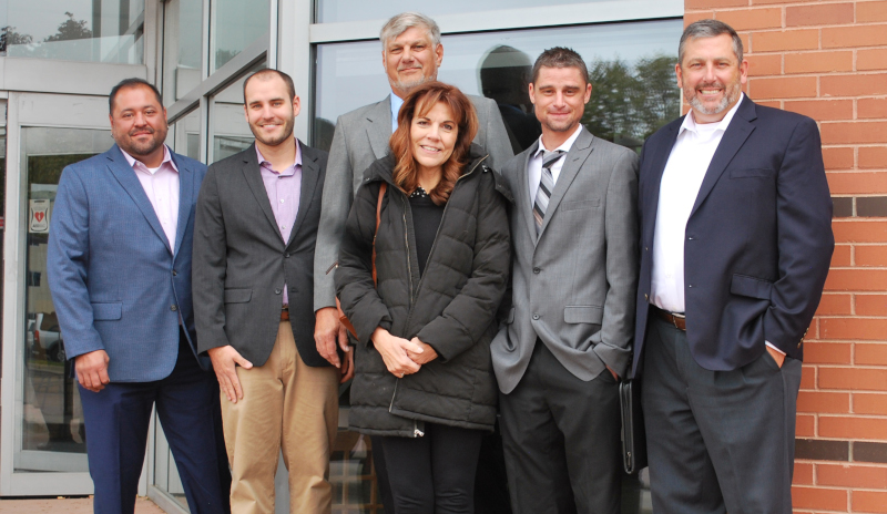 Rocky Mountain Metropolitan Airport staff award photo showing a group of people dressed up in front of a building.