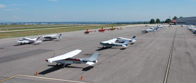 Rocky Mountain Metropolitan Airport runway with small craft parked and in transit.