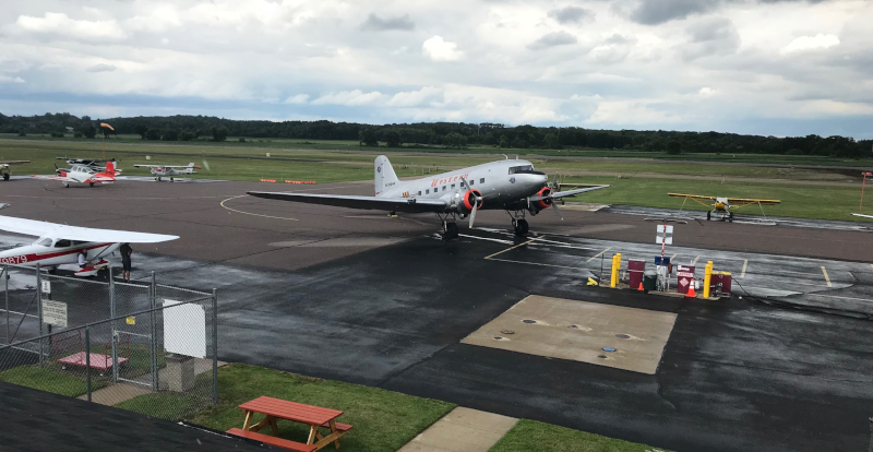 Baraboo-Wisconsin Dells Airport runway with an old prop plane with Western on the side.