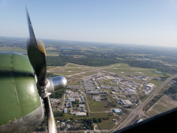 Bartow Executive Airport aerial view from a prop plane and one engine in view.