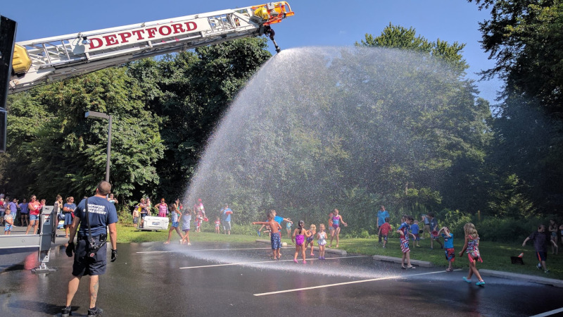 Deptford Township, New Jersey fire department spraying water on kids from a ladder.