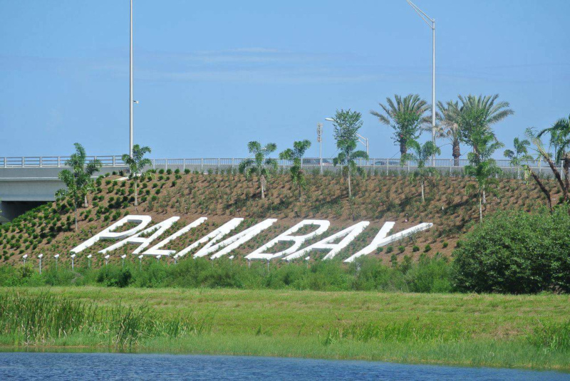 Palm Bay, Florida sign along the highway in the landscaping.