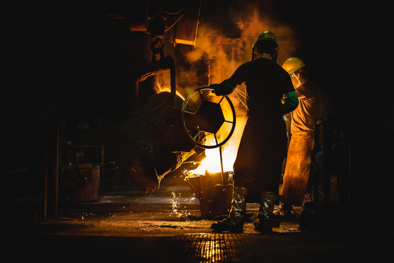 The Buck Company employees pouring molten metal.