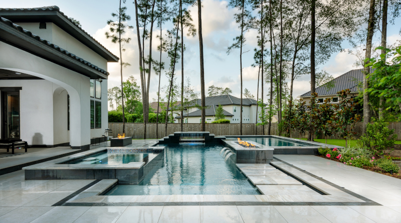 Regal Pools example of work showing a nice outdoor pool behind a house.