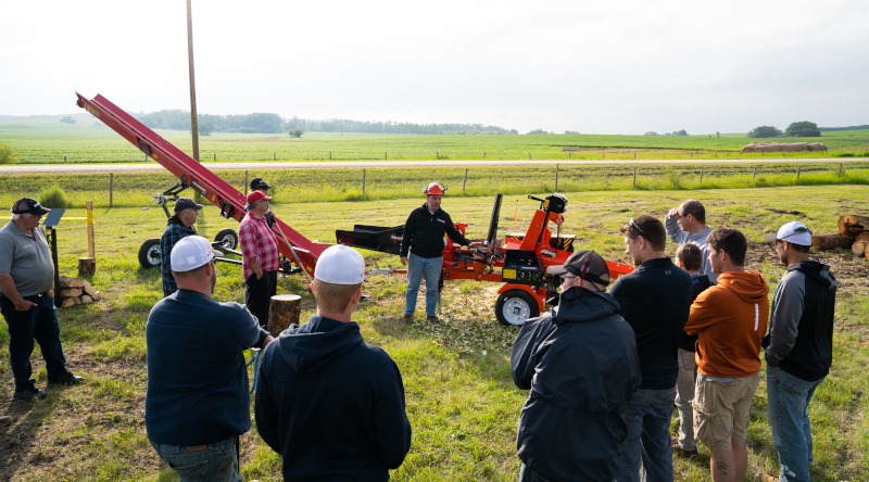 Wallenstein Equipment Inc. team photos with equipment in a grassy area.