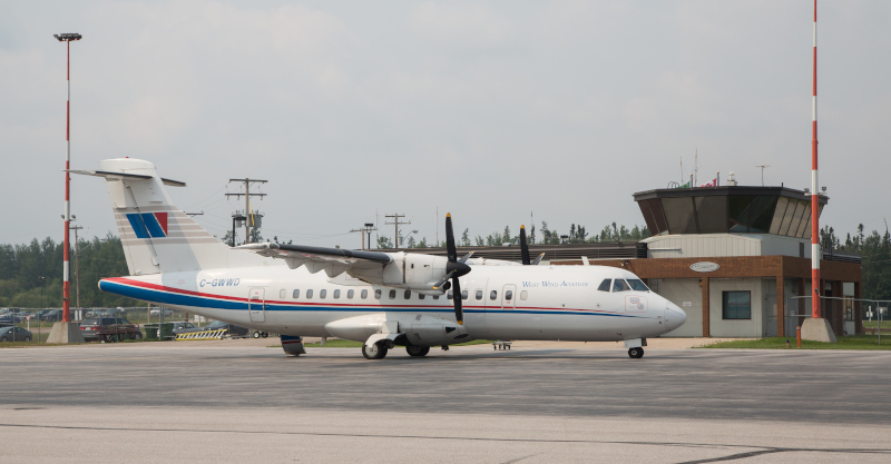 Barber Field Airport, La Ronge plane on the runway with the control tower behind.