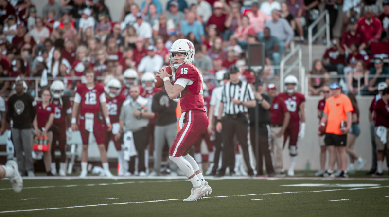 Buffalo Stadium football game with a quarterback getting ready to throw.