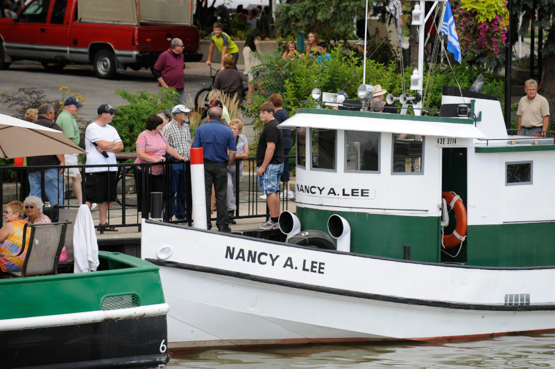 Chatham-Kent, Ontario commercial boat docked with people nearby.