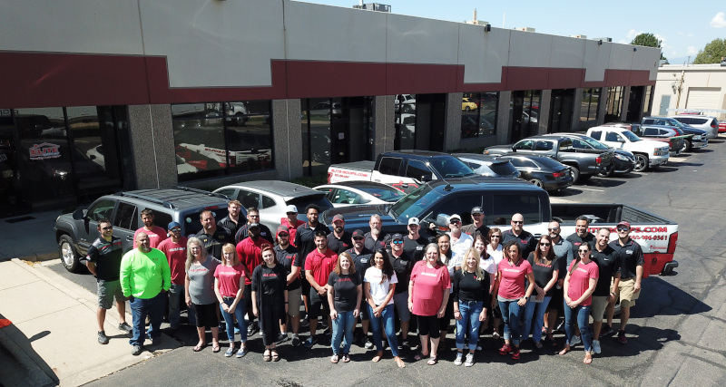 ELITE Roofing group of employees standing in the parking lot.