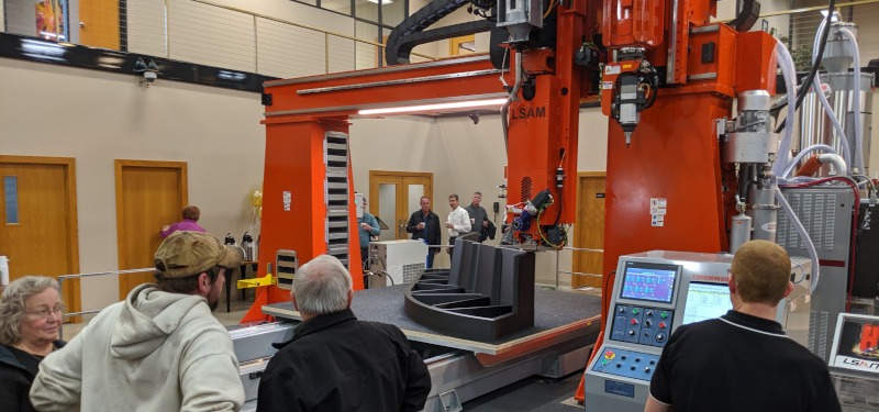 Thermwood Corporation people looking at a large machine.