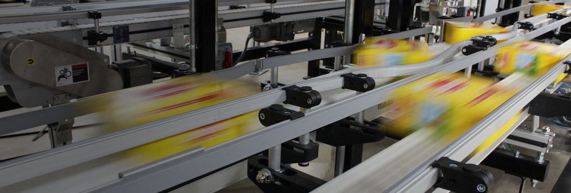 Simplimatic Automation Simpli Flex Conveyor showing items moving so fast they are blurry in the image.