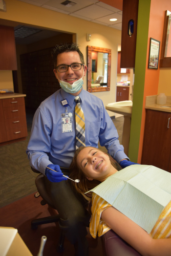 Light Dental Studios Dentist and patient being worked on.