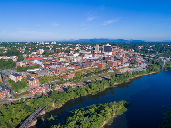 Lynchburg, Virginia aerial view showing it alongside the James River with the Blue Ridge Mountains behind.