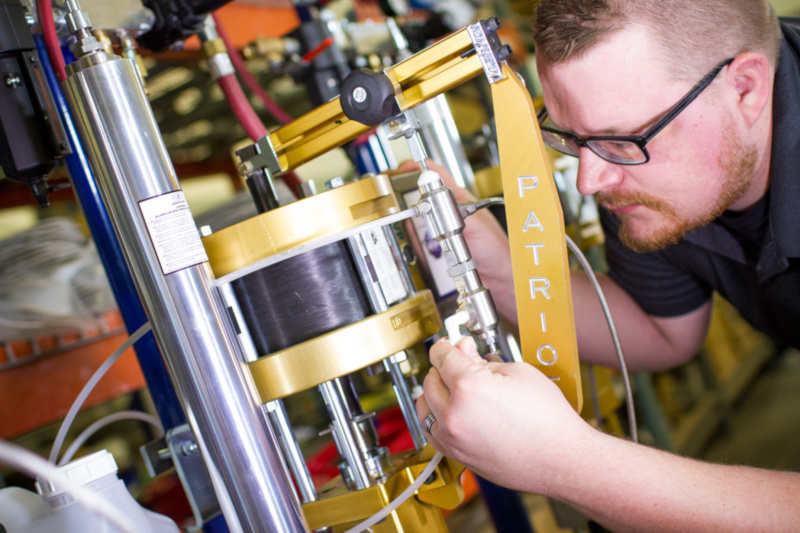 Magnum Venus Products employee working on equipment.