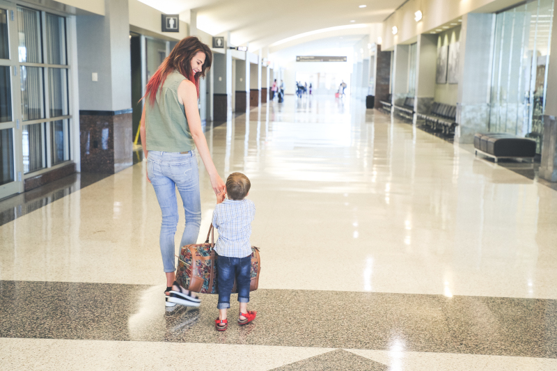 Rick Husband Amarillo International Airport mom and son walking inside airport.