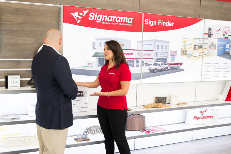 Signarama Deerfield employee talking with customer.