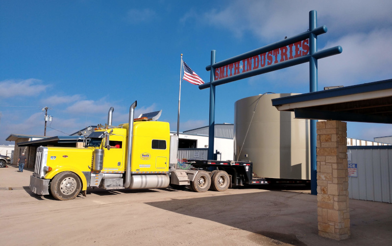 Smith Industries Inc. Semi truck and company sign.