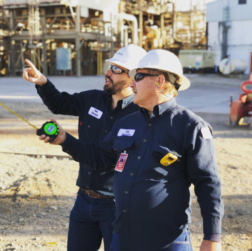 Norwest Engineering men in hard hats pointing to the left.