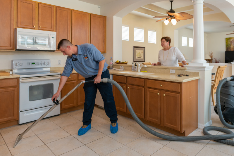 United Water Restoration Group, Inc. employee working on a customers kitchen floor.