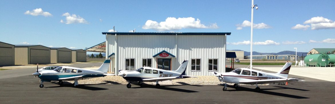 Deer Park Municipal Airport building with planes out front.
