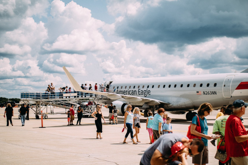 The Kalamazoo / Battle Creek International Airport runway with an American Eagle jet and lots of people.