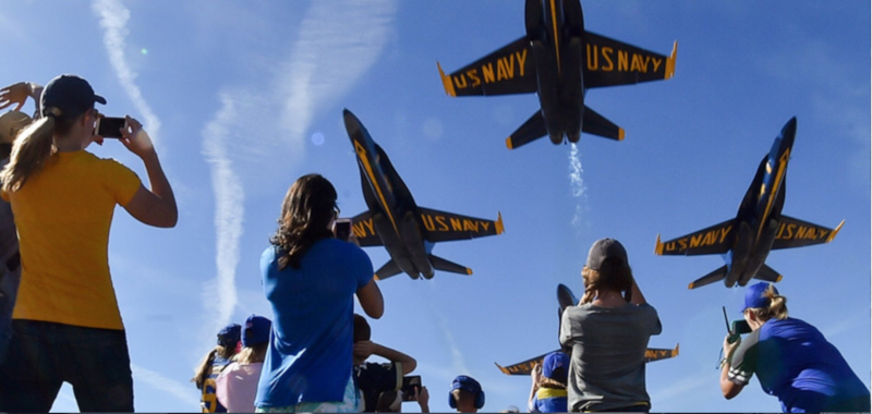 Terre Haute Regional Airport airshow with jets over head of other people taking photos.