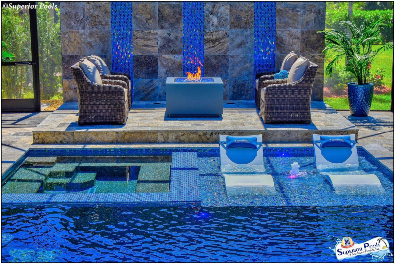 Superior Pools example of work showing an outdoor pool area with seating in and out of the water.