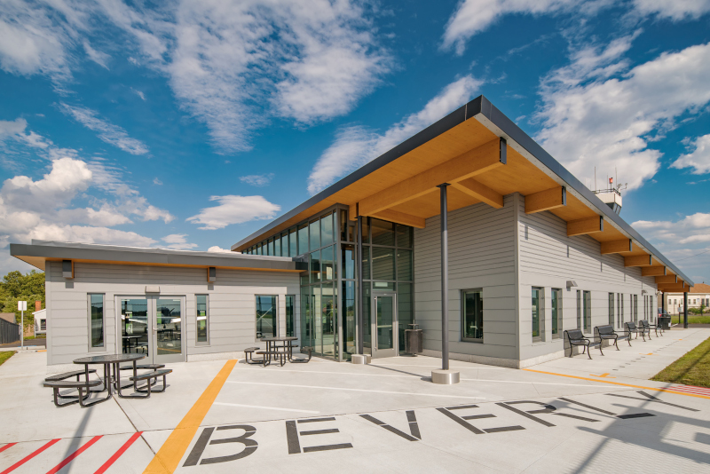 Beverly Regional Airport exterior with blue skies and Beverly written on the ground..