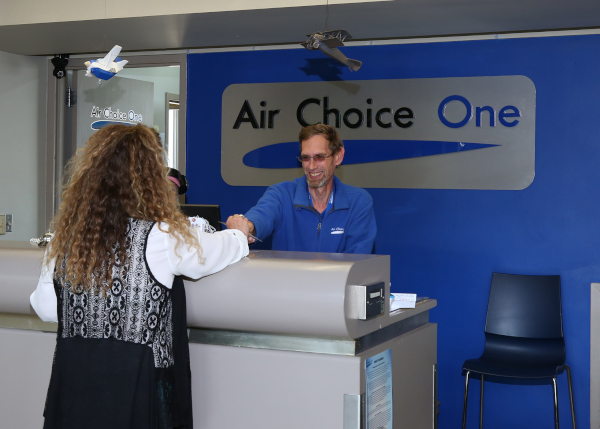 Mason City Municipal Airport MCW Air Choice counter with employee and customer.