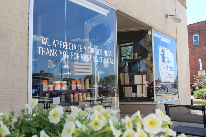 Jacksonville, Illinois local store front with sign reading " We Appreciate Your Business Thank you for keeping it local".