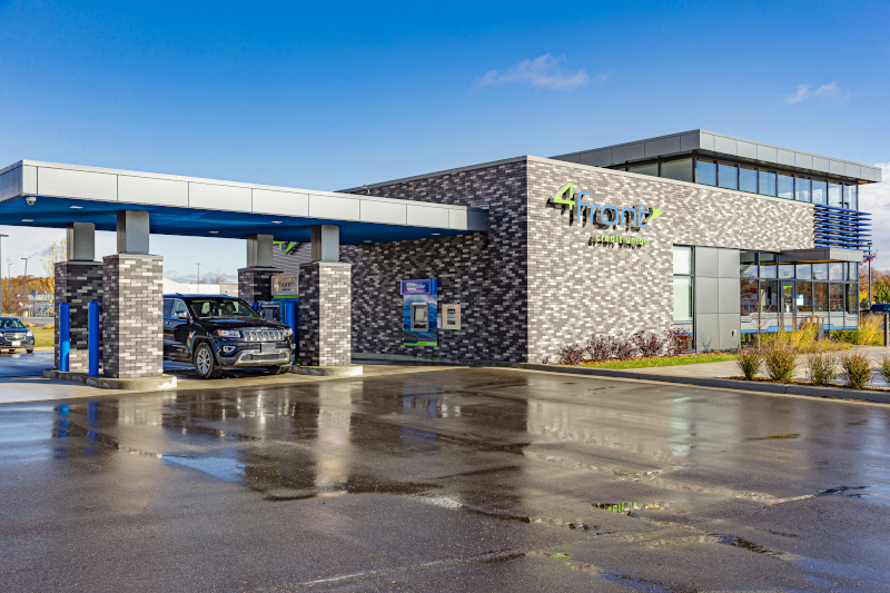 4Front Credit Union Cadillac Branch building exterior with a car at the drive through.