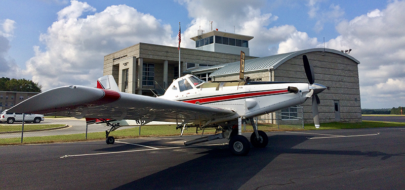 The Heart of Georgia Regional Airport is located three miles east of the City of Eastman in South Central Georgia, and services general aviation air traffic from all over the southeast United States. The Airport was originally built by the State of Georgia for the Stuckey’s Corporation to support its business operations. “Mr. W.S. Stuckey, who started the candy company here in Eastman, Georgia, selling pecan log rolls by the side of the road, kept expanding and started putting stores all up and down the Interstate,” explains Airport Manager, Jeff Fordham. “They had a Piper Aztec, and their airstrip was not long enough, so they came out here and built the Airport because they needed a place to land their bigger planes.” When the facility was officially dedicated in December 1966, then Governor Carl Sanders hailed the $232,000 Eastman-Dodge County Airport as “the first community airport in Georgia that we have built specifically to accommodate the modern business jet airplanes that are becoming so important in one industry after another.” Today, the Heart of Georgia Regional Airport is owned and operated by Heart of Georgia Regional Airport Authority and is overseen by a seven-member Board of Directors, made up of two members from the Eastman City Council, two members from the Dodge County Board Commissioners Office – one is a sitting board member from each of those, and one is an at-large appointment - and two members from the Dodge County-Eastman Development Authority – one is a board member, one is an at-large appointment. The seventh member is appointed by the Georgia House of Representatives. The Airport’s original 4,500-ft. runway was lengthened to 6,506 feet in 2004, and equipped with a precision instrument landing system and a landing capacity of 100,000 pounds. A new terminal and tower were completed in 2005. The Airport supports between 300-400 operations per day, comprised of general aviation, corporate, military, flight training, customs and border patrol, air ambulance, and aerial agricultural traffic, making it the 5th busiest take-off and landing airport in the state. Over the last several years, the Heart of Georgia Regional Airport has also become a major aviation education presence in the Southeast. It is home to Middle Georgia State University’s Aviation Center – Georgia’s only state-supported aviation center – which trains pilots and airport and airline management majors, while giving airframe and power plant students the skills required to build and maintain aviation assets. The school’s flight program is FAA-approved, and its campus at the Airport is home to a fleet of 30 airplanes, four helicopters, and several advanced simulators used in training and instruction. In 2007, the school’s Air Traffic Control Management program was named the top new ATC program in the nation by the FAA. The Airport is also home to several aviation manufacturing and maintenance firms. Fordham Aviation Inc. provides aircraft maintenance services; KENCOA Aerospace LLC is a premier Tier-1 supplier of multi-axis precision machined and sheet metal fabricated aerostructures, jet engine components, and major assemblies for commercial, military, and business/regional jets, worldwide; AREMAC Heat Treating East, LLC, is a nationally recognized heat treatment company; and Valence Surface Technologies is a full-service metal finishing company for the aerospace industry. Machining, heat treatment, and finish coating, located next door to each other on the same airport – a unique capacity that isn’t repeated anywhere in the country – means a much faster turnaround for parts manufacturing and final delivery to companies such as Boeing, Airbus, Lockheed-Martin, Gulfstream, and Sikorsky. All of this activity means that the Heart of Georgia Regional Airport plays a vital role in supporting the region with 376 jobs with an annual payroll of $14,700,000, and $37,169,000 in economic output for the local and regional economies. As airport tenancy continues to grow – there are currently around 60 private and corporate home-based aircraft on property - Fordham says that he would like to see more hangars built by private developers - as opposed to the county footing the bill. “Right now, everything is owned by the Airport and rented out. We have 18 hangars and they’re all full. There’s a lot of land on the west side of the airport; most everything has been developed on the east side. I think there’s a couple of hundred acres, at least, that’s available to develop with more to be obtained if we need it,” he notes. “We’re getting ready to do an apron re-hab project – we’re still working on the cost for that; it should be somewhere around a million dollars. We also want to put in a taxiway into an area where we can build more hangars or have ground leases so others can build hangars. I think it’s better if people build their own hangars.” Fordham says that the Airport’s 6,506-ft. runway is currently able to handle any normal traffic. “There was some talk about lengthening the runway, but we haven’t gotten that solidified yet,” he shares. “Right now, we’ve got a very good runway with two parallel taxiways and the pavement is in pretty good shape. So, I don’t foresee having any resurfacing projects within the next five years or so.” Regarding any potential competition from nearby airports, Fordham says that Heart of Georgia has lots of services available that one wouldn’t necessarily find elsewhere. “We have everything from catering, to courtesy cars, to 24-hour fuel availability for jets and pistons,” he reports. “And our normal operating hours are a little bit longer; we’re open 8-5 Monday through Saturday, and 12-5 on Sunday. And we don’t mind staying till seven or eight o’clock at night if we need to. A lot of airports, after a certain hour, you can’t get anybody; but we’re pretty much available 24/7 if anyone calls. With COVID, we had to cut back on our hours, but we try to pride ourselves on our accessibility and our customer service.”