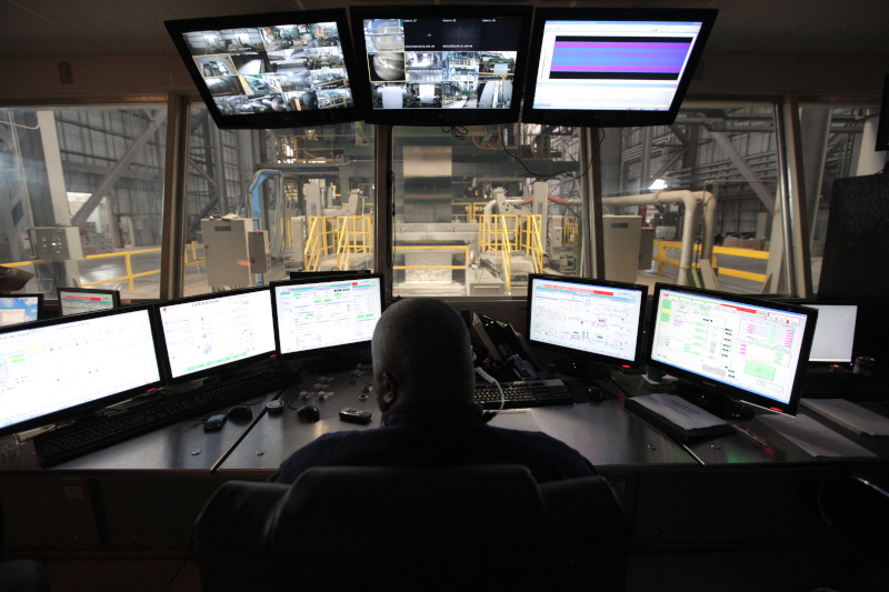 American Iron and Steel Institute. A person in a room with monitors overlooking production area.