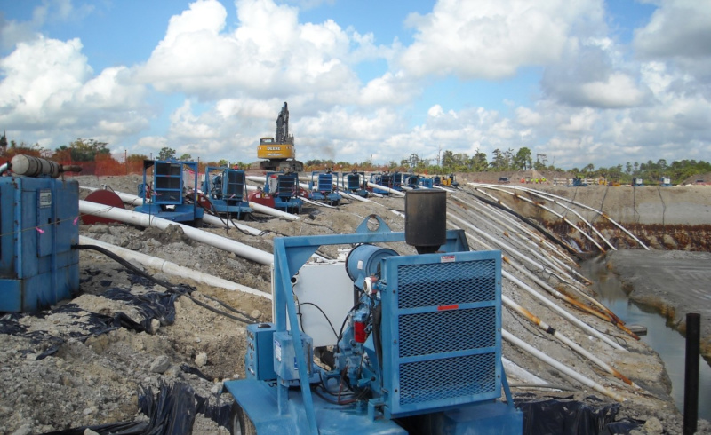 Holland Pump Company a row of pumps set up at a site with hoses leading down to the right