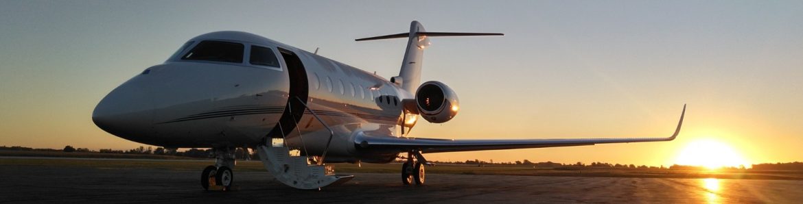 Allen County Airport jet on the runway with the sun setting behind