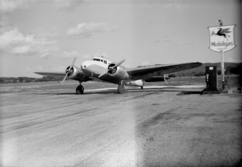 La Crosse Regional Airport, old photo with an old style prop plane and an old mobilgas pump next to the runway