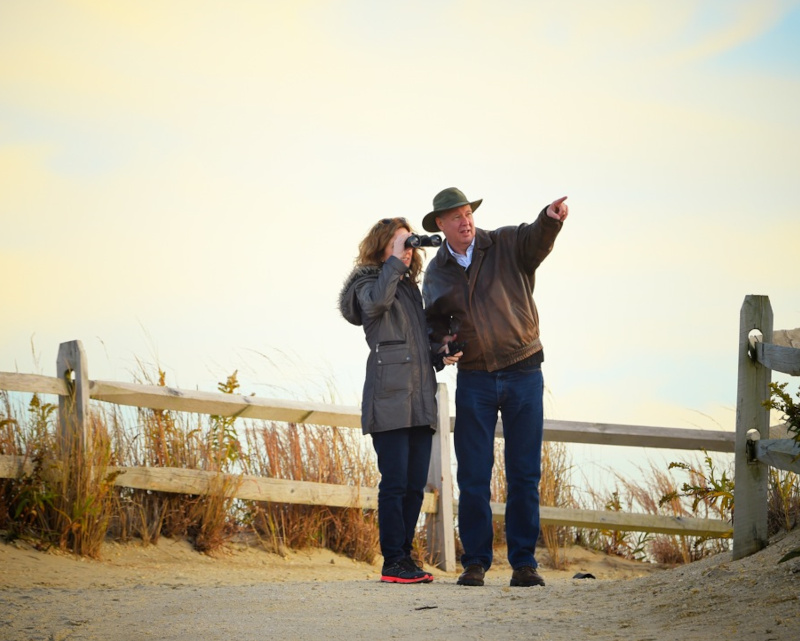 Cape May County, New Jersey couple looking beach pointing, binoculars