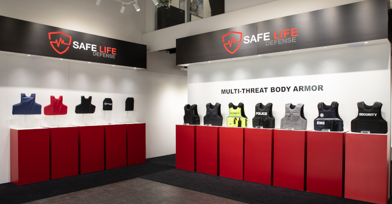 Safe Life Defense display with multiple pieces of body armor on top of cabinets