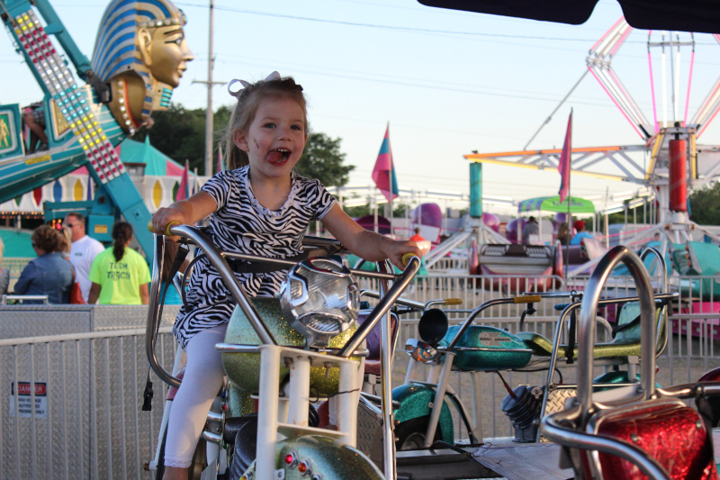 Washington, Illinois Girl riding a ride at Cherry Fest